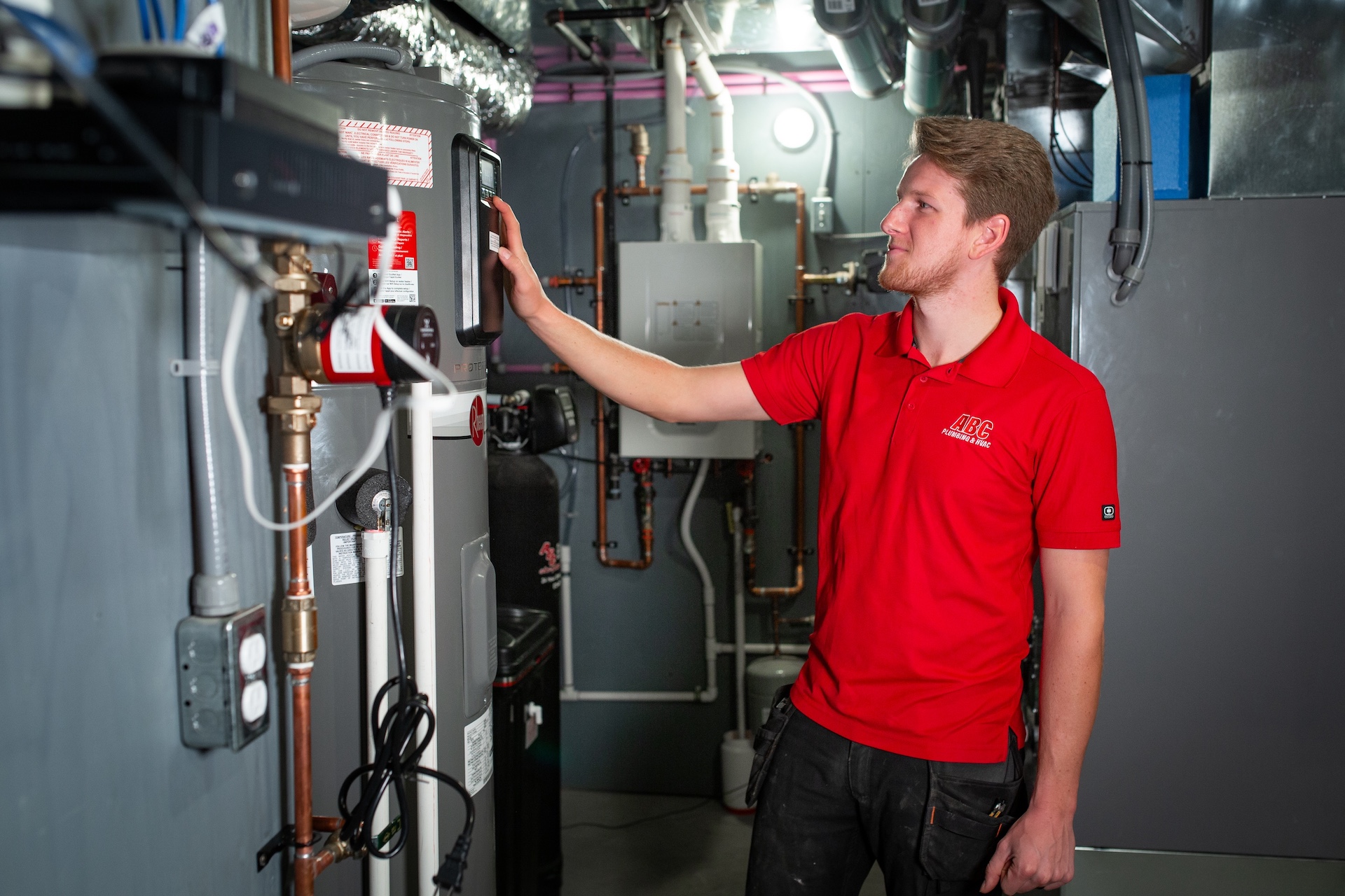 HVAC technician working with a water heater in Ottawa